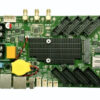 Green development board with a large black heatsink, yellow coin-cell battery, USB ports, and multiple edge connectors.