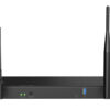 Black wireless router with two external antennas, resting on a flat surface; front panel shows status LEDs and a USB 3.0 port toward the right.