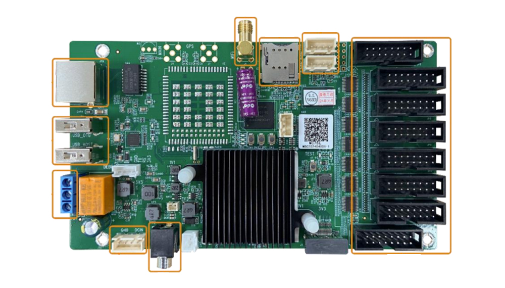 Green PC motherboard with a large black heatsink and many expansion slots outlined in orange](https://)
