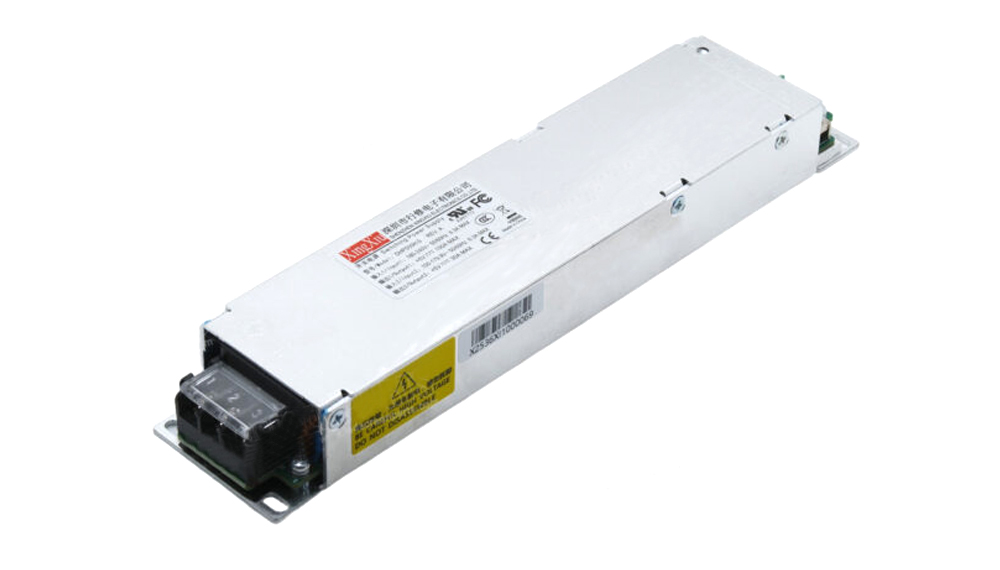 Silver rectangular industrial power supply module with a black terminal block at the end and yellow warning label on its side