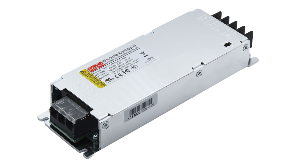 Metal-encased switching power supply with screw-terminal output and cooling fins on one end, ready for installation in equipment