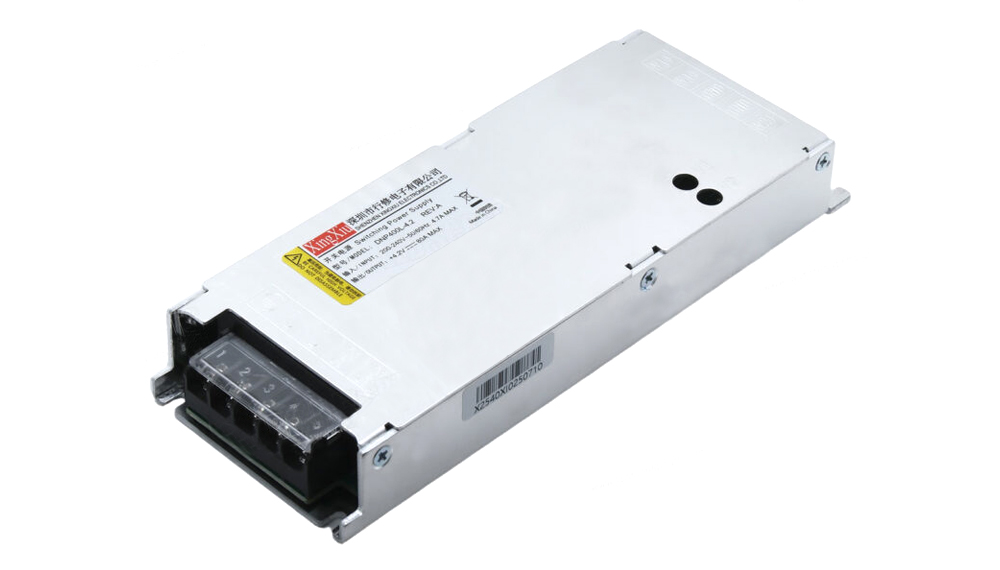 Industrial power supply unit with a 4-terminal output block on a metal enclosure; includes warning label on top surface.