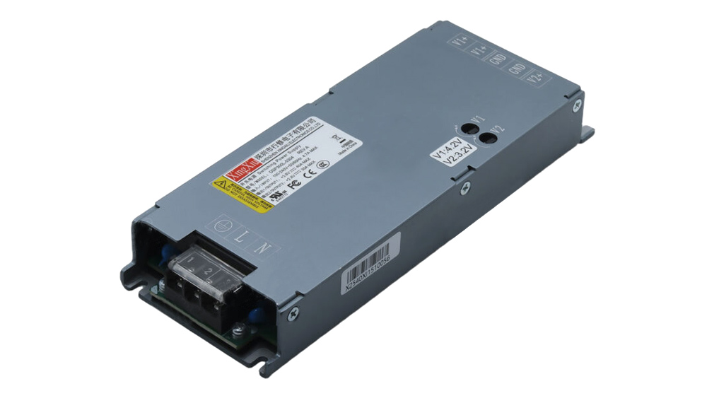 Industrial DC power supply module in a gray metal enclosure with a terminal block at one end and mounting flanges on the sides.